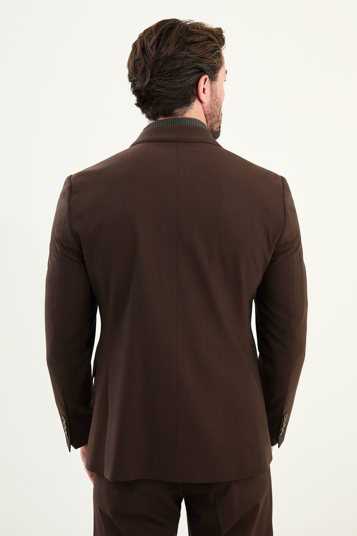 Men’s dark brown chocolate/espresso slim-fit double-breasted 6x2 suit with peak lapels, cotton-wool-viscose blend with 4-way stretch for wrinkle-resistant wear, styled with a cream or dark olive turtleneck.