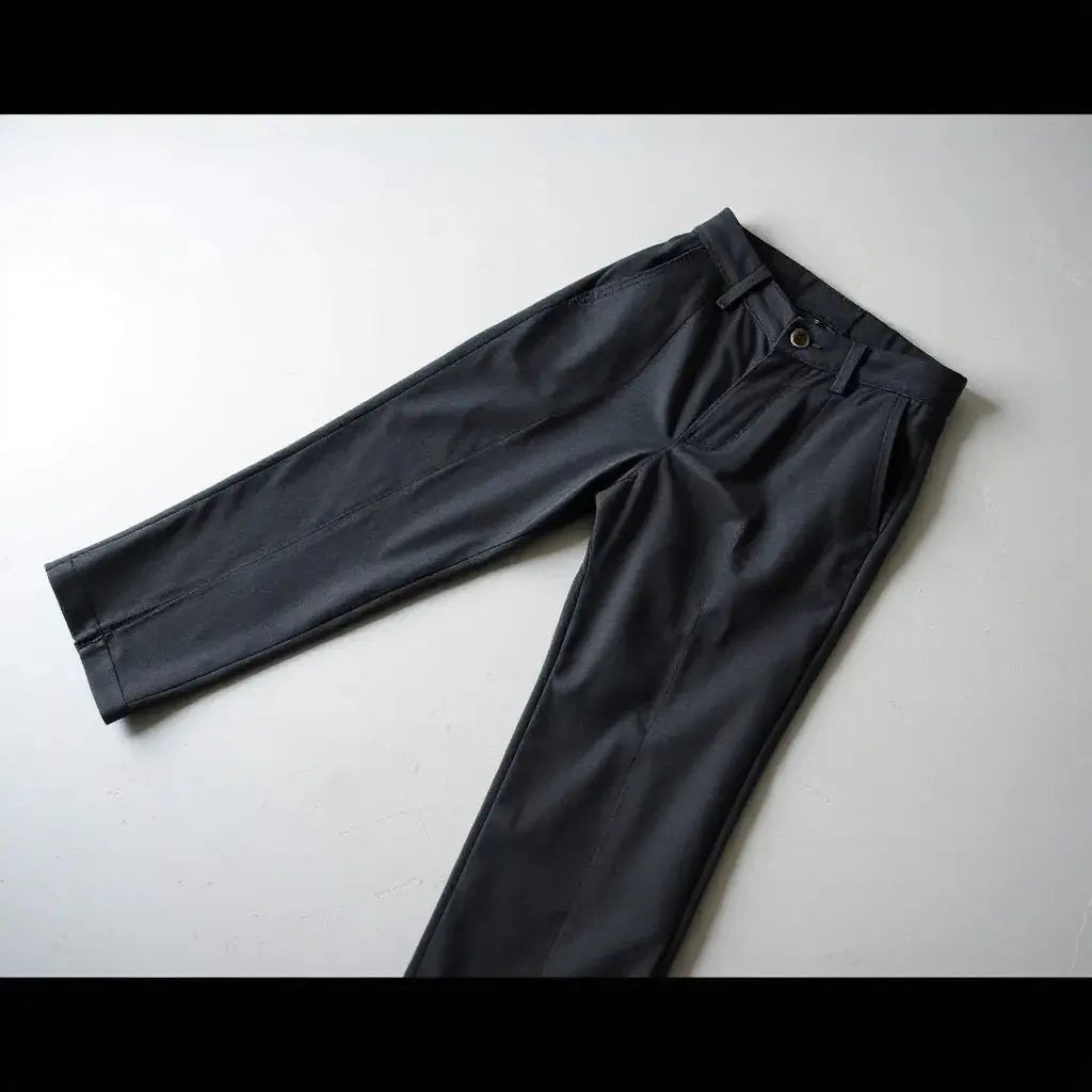 Tailored sidetab design trousers with visible waistband tab detailing and crisp seams on a clean studio surface