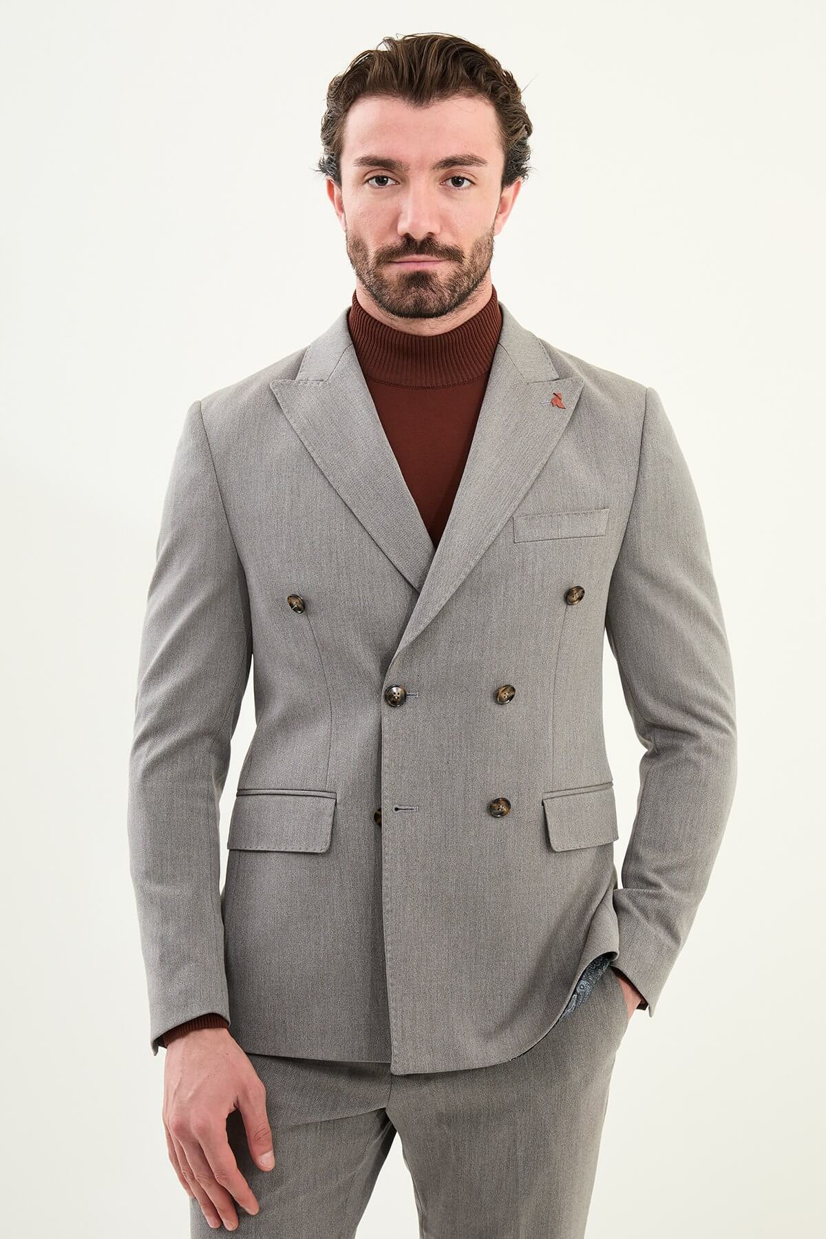 Men’s heather gray slim-fit double-breasted wool-blend suit with wide peak lapels, barchetta chest pocket, tortoiseshell buttons, and red origami lapel pin.