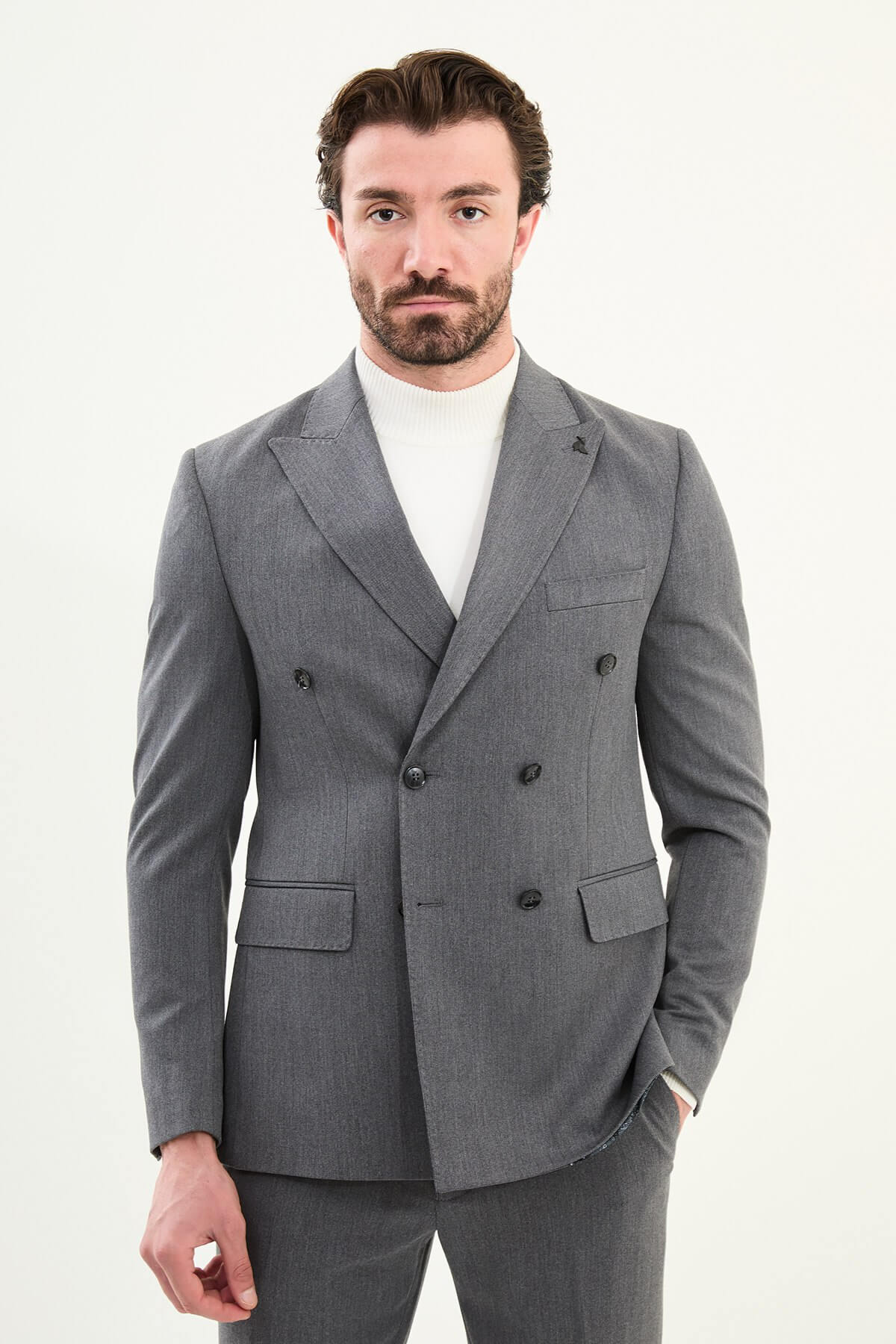 Men’s heather gray slim-fit double-breasted wool-blend suit with wide peak lapels, point-stitch lapel edges, barchetta chest pocket, mottled buttons, and origami lapel pin.