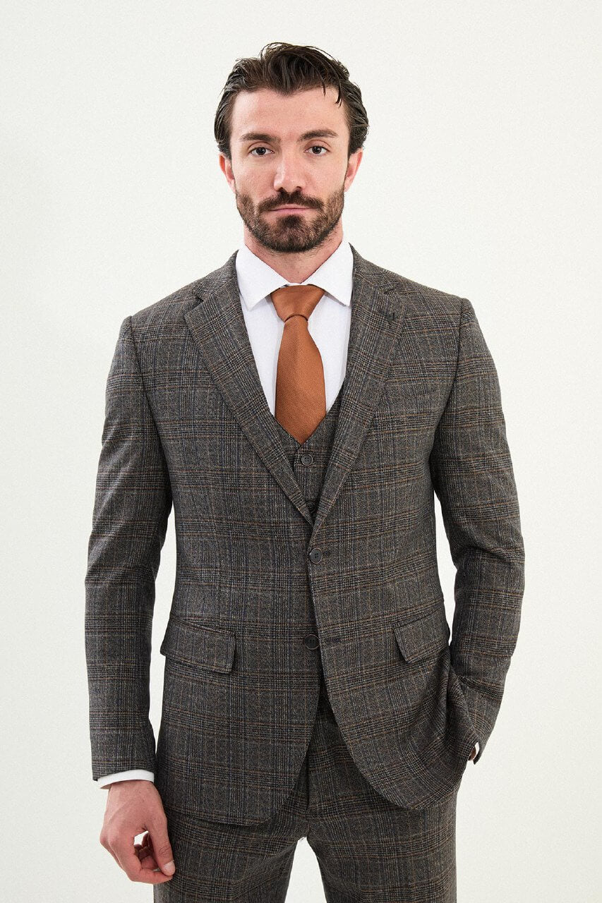 Men’s brown glen plaid slim-fit three-piece wool-blend suit with single-breasted two-button jacket, notch lapels, patch pockets, five-button waistcoat, tapered trousers, barchetta chest pocket, and black origami lapel pin.