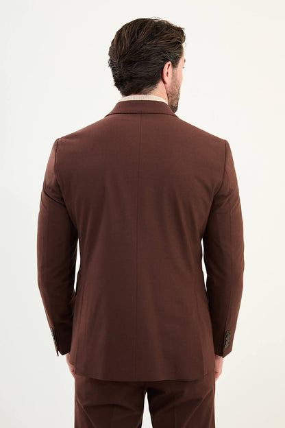 Men’s deep chocolate brown slim-fit double-breasted 6x2 suit with peak lapels, cotton-wool-viscose blend with stretch, designed for breathable comfort and wrinkle-resistant wear, styled with a cream turtleneck.