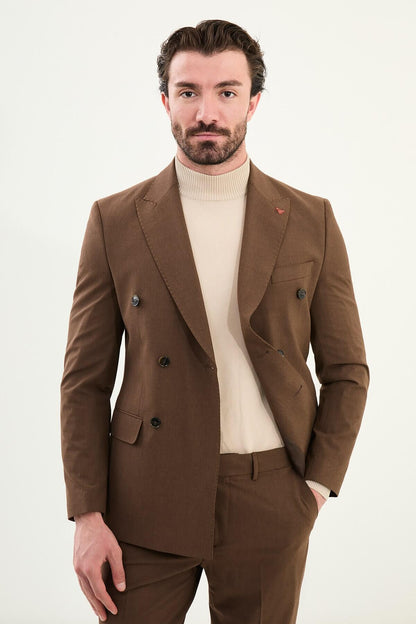 Men’s deep brown slim-fit double-breasted 6x2 suit with peak lapels and patch pockets, cotton-wool-viscose blend with 4-way stretch for wrinkle-resistant wear, styled with a cream turtleneck.
