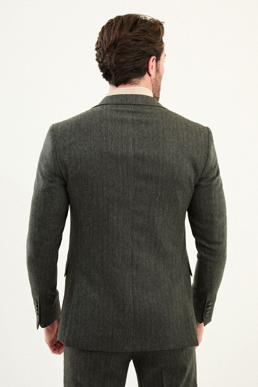 Men’s olive-toned khaki herringbone slim-fit single-breasted suit with structured shoulders and tailored waist, high-wool blend fabric with stretch for winter wear, styled with a cream fine-gauge turtleneck.