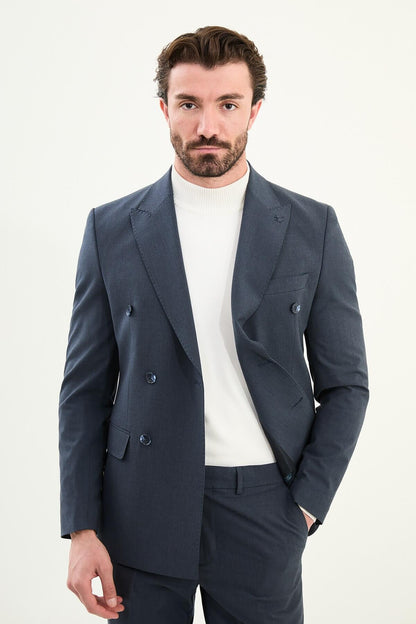 Men’s navy blue slim-fit double-breasted 6x2 suit with peak lapels, matte micro-texture finish, cotton-wool-viscose blend with stretch for wrinkle-resistant wear, styled with a white turtleneck.